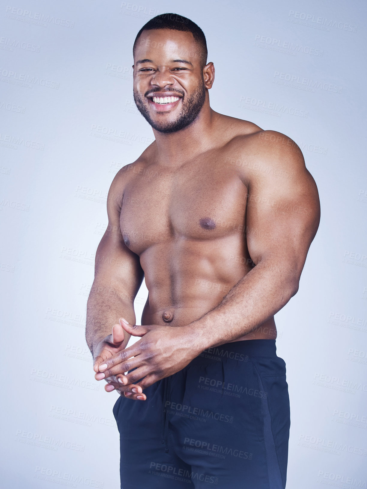 Buy stock photo Black man, portrait and shirtless in studio with fitness for healthy body, happy and muscle power with confidence. Bodybuilder, athlete and smile with wellness and arm strength on blue background