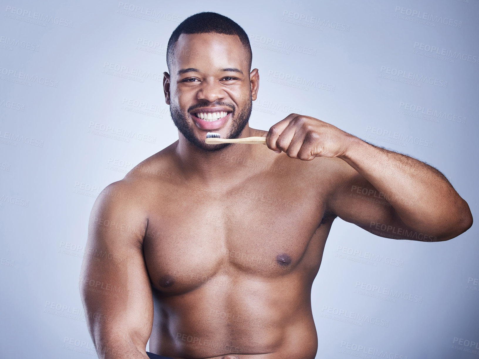 Buy stock photo Black man, toothpaste and brushing teeth in studio portrait, smile and oral health on blue background. Person, toothbrush and dental hygiene for fresh breath, healthcare and grooming for whitening