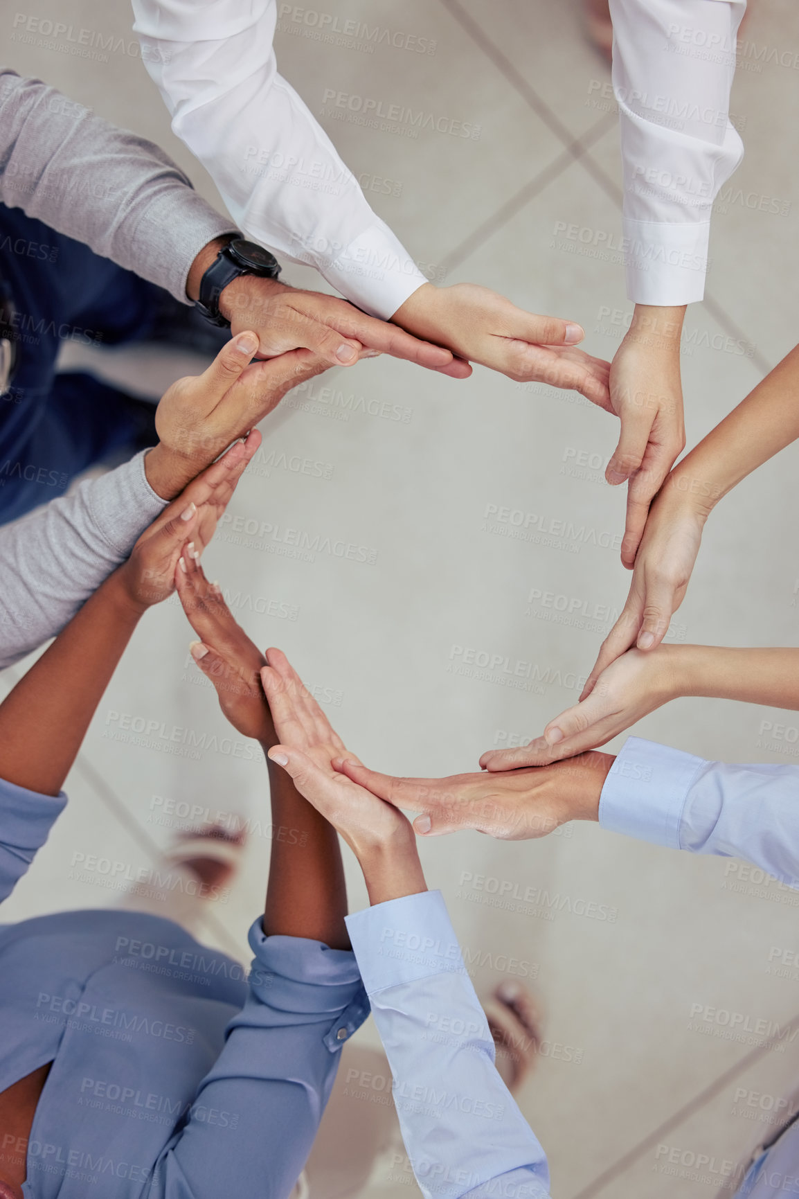 Buy stock photo High angle shot of a group of unrecognizable businesspeople forming a circle with their hands at work