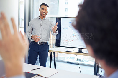 Buy stock photo Shot of a young businessman raising his hand to ask a question in a meeting at work