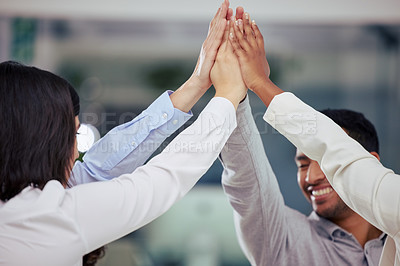 Buy stock photo Shot of a group of businesspeople giving each other a high five at work
