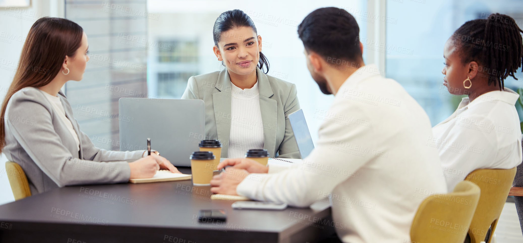 Buy stock photo Shot of a group of businesspeople meeting in the boardroom