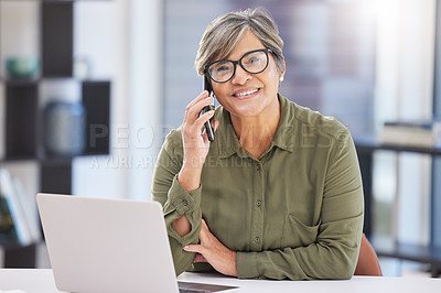Buy stock photo Shot of a mature businesswoman sitting alone in the office and using her cellphone