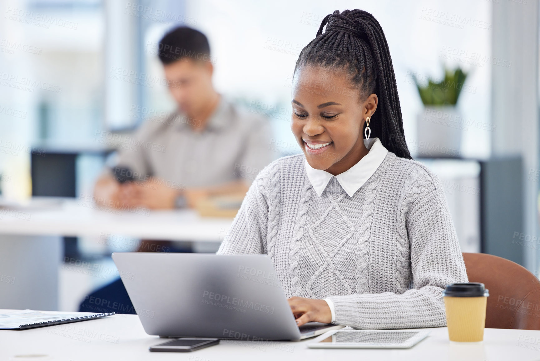 Buy stock photo Shot of an attractive young businesswoman sitting in the office and using her laptop