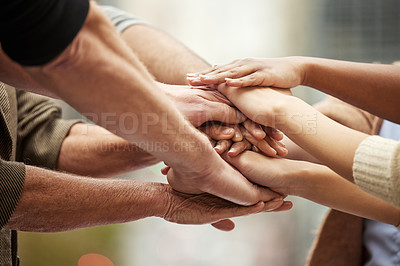 Buy stock photo Closeup shot of a group of unrecognisable people joining their hands together in a huddle