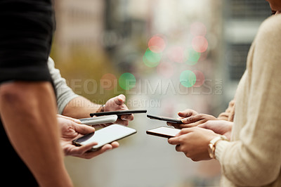 Buy stock photo Closeup shot of a group of unrecognisable people using their cellphones in synchronicity