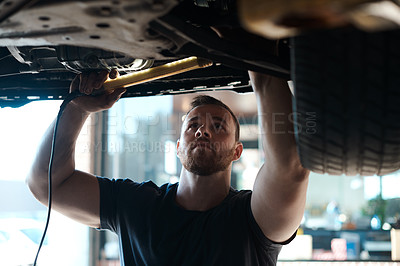 Buy stock photo Light, inspection and mechanic with car in workshop for service, maintenance or repair for safety. Torch, auto engineering and male industrial worker checking bottom of vehicle for oil leak in garage