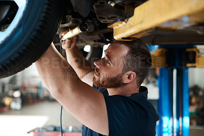 Buy stock photo Light, inspection and mechanic with car in garage for service, maintenance or repair for safety. Torch, auto engineering and male industrial worker checking bottom of vehicle for oil leak in workshop