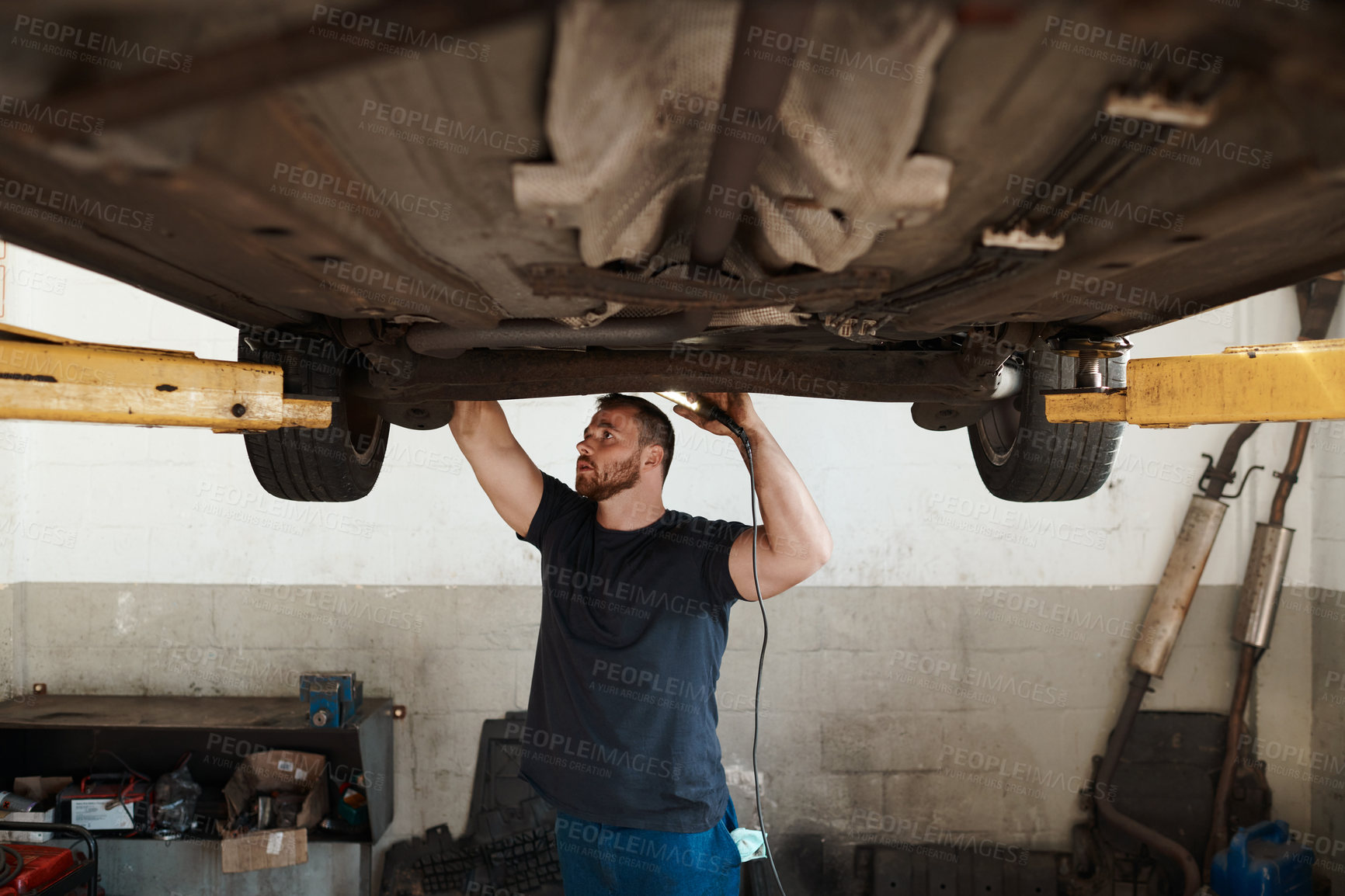 Buy stock photo Mechanic, man and inspection for vehicle, maintenance and car service for safety in workshop. Male person, working and motor in garage for repair, check and care for performance and trade value