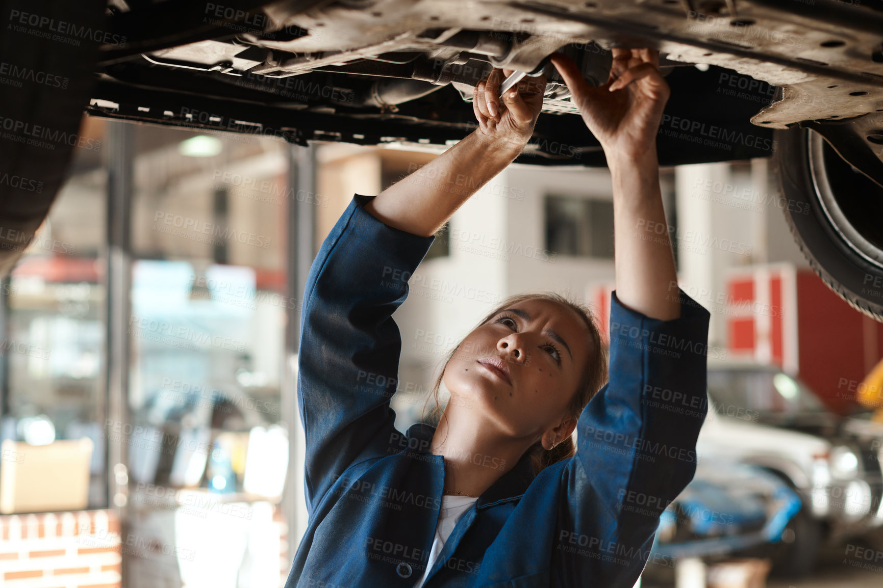 Buy stock photo Woman, checking and tool for service with car in garage, inspection or maintenance on engine. Female mechanic, auto and wrench for problem with oil or motor, technician working or repair on transport