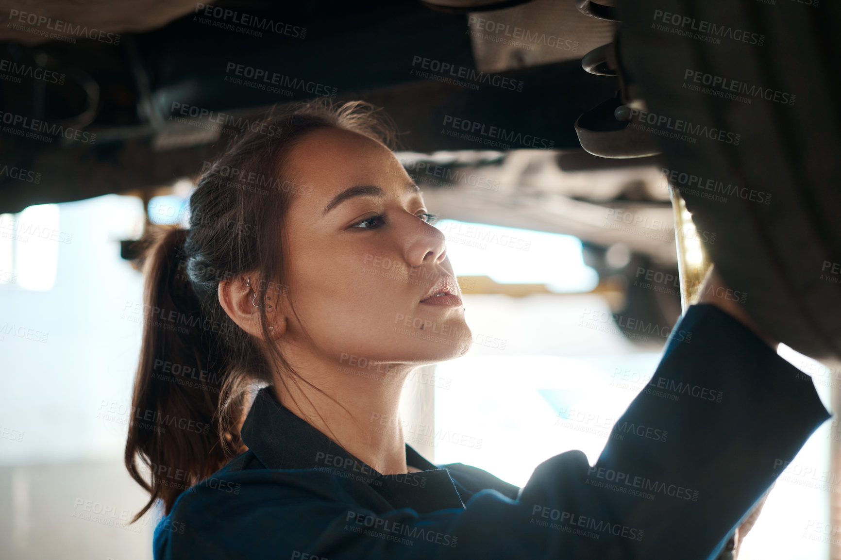 Buy stock photo Woman, inspection and tool for service with car in garage, check or maintenance on wheel. Female mechanic, auto and happiness for problem with motor tyre, technician working or repair on transport