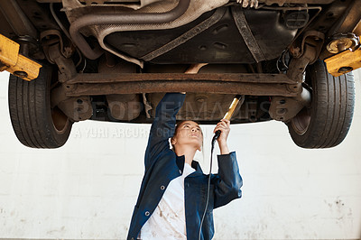 Buy stock photo Woman, check and tool for service with auto in garage, inspection or maintenance on engine. Female mechanic, car and torch for problem with oil or motor, technician working or repair on transport