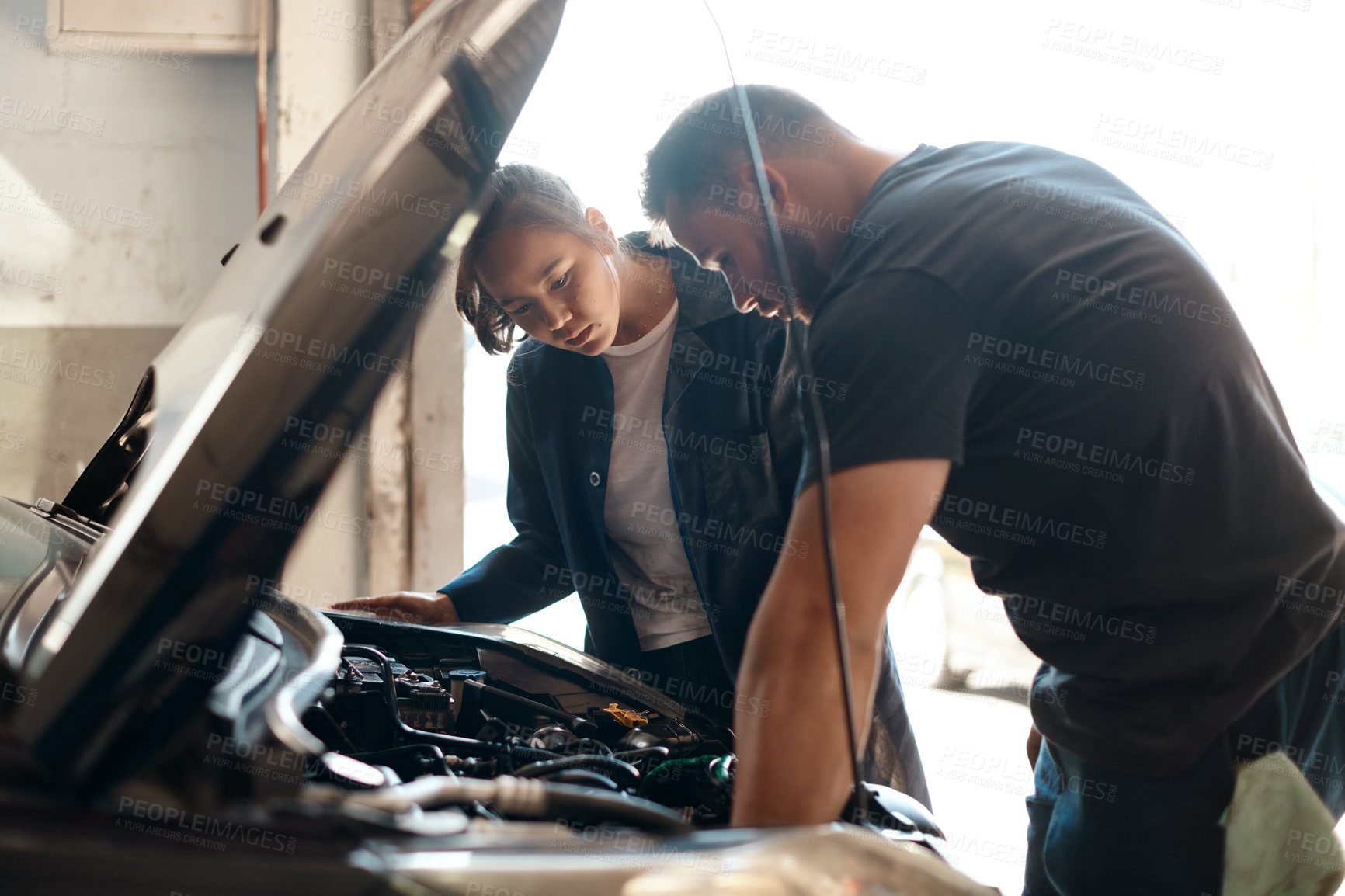 Buy stock photo People, mechanic and car engine with teamwork, conversation and inspection for maintenance. Employees, entrepreneur and coworkers with vehicle issue, industry and cooperation with solution in garage