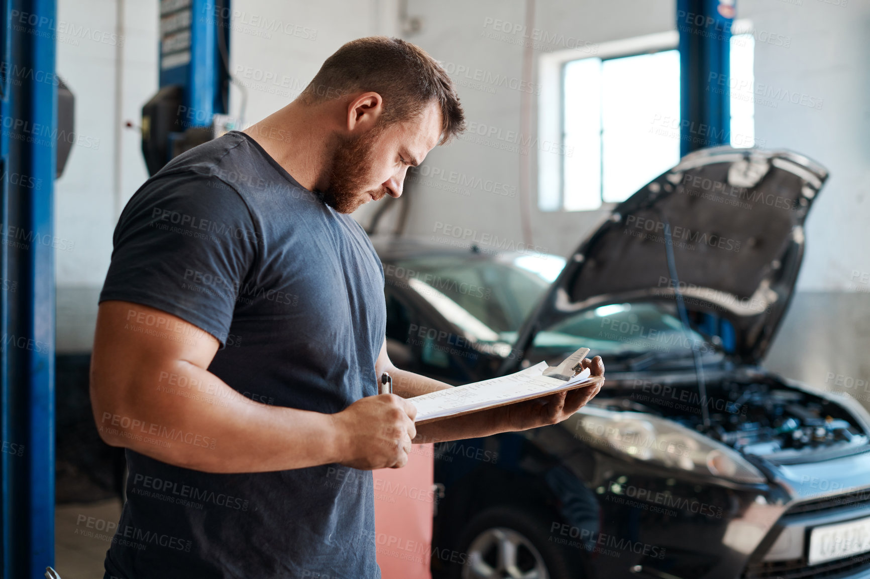 Buy stock photo Man, mechanic and clipboard for repair services and car maintenance or safety check in workshop with documents. Strong engineer or worker in garage or auto shop with checklist or inspection paperwork