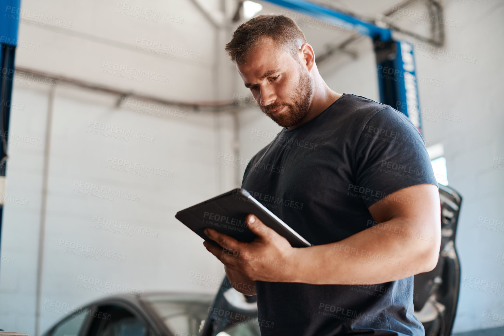 Buy stock photo Man, car mechanic and workshop with tablet for maintenance or inspection with online information and instructions. Checklist, employee and vehicle repairs as engineer with small business and garage