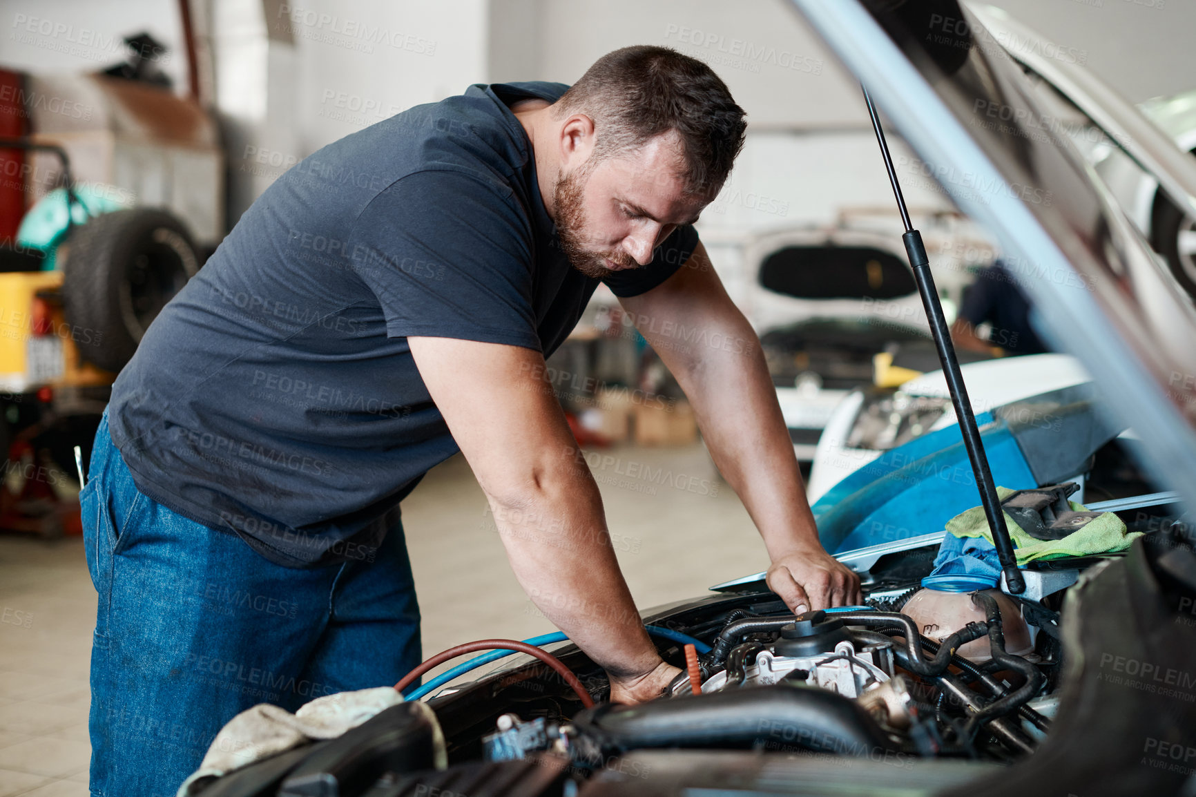 Buy stock photo Man, car mechanic and garage on engine for inspection or maintenance and service as technician. Diagnosis, employee and vehicle repairs on bonnet as engineer with small business, startup and garage