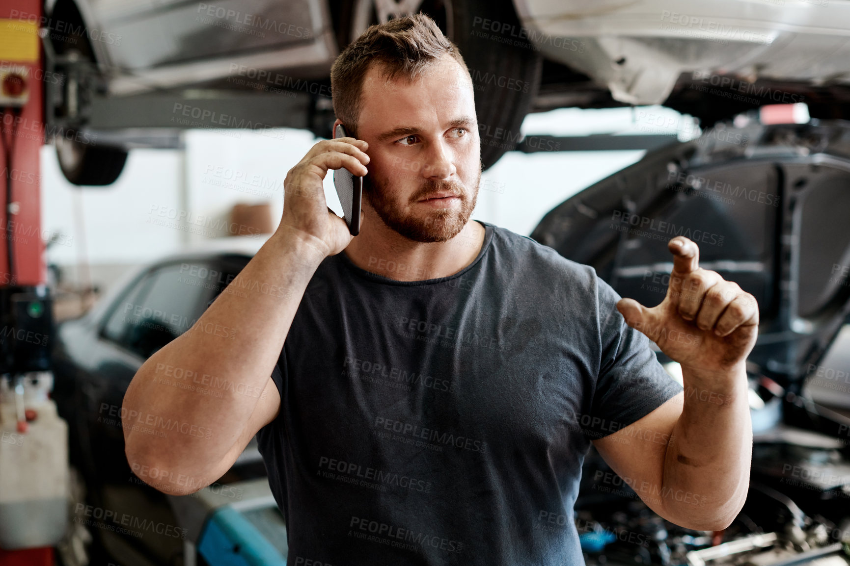 Buy stock photo Car, mechanic and phone call with man in workshop for maintenance, repair or service. Auto, communication and expert with serious vehicle engineer or technician in garage for transport inspection