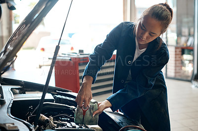 Buy stock photo Car, mechanic and oil with woman in workshop for maintenance, repair or service of engine. Auto, expert and inspection with asian vehicle engineer or technician checking dipstick in industry garage