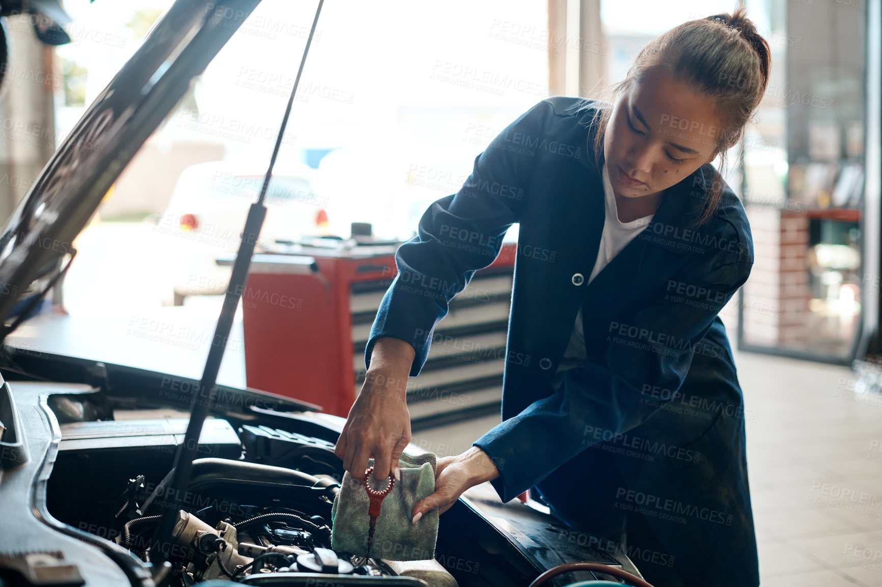 Buy stock photo Car, mechanic and oil with woman in workshop for maintenance, repair or service of engine. Auto, expert and inspection with asian vehicle engineer or technician checking dipstick in industry garage