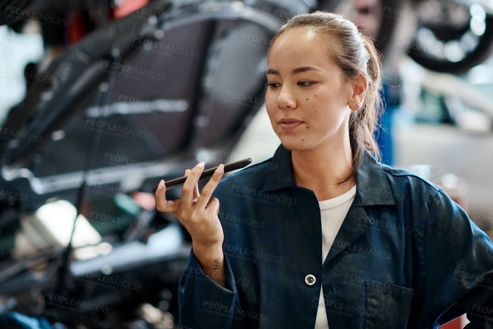 Buy stock photo Female mechanic, smartphone and repairs in garage for internet, research and car service in workshop. Woman, reading and technology with information for ideas, maintenance and quality assurance