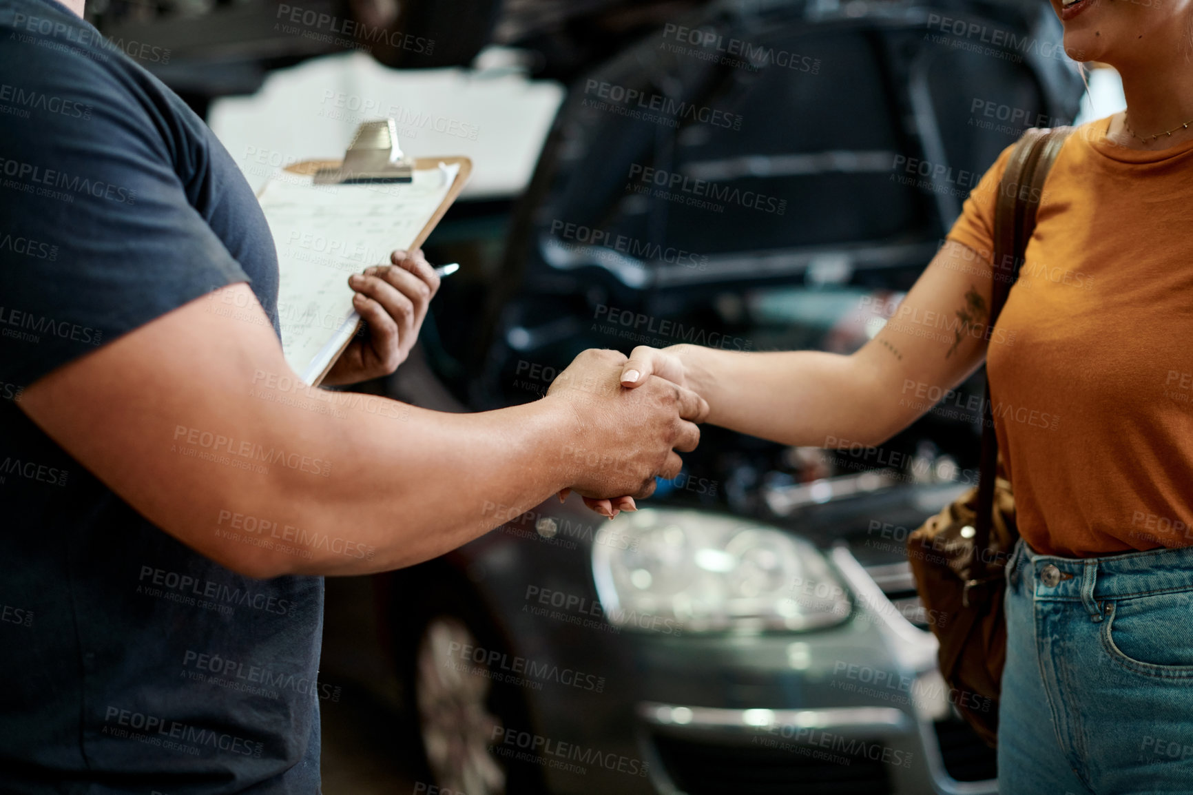 Buy stock photo Handshake, deal and woman with mechanic in workshop for contract on vehicle repair or maintenance. Clipboard, agreement and female person shaking hands with industry worker in garage for car service.