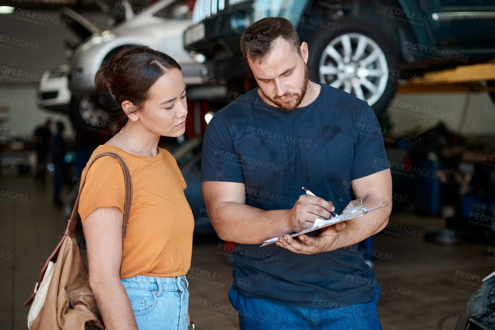 Buy stock photo Woman, mechanic and sign paperwork in auto repair shop, invoice and service for car maintenance bill. Female person, clipboard and customer for vehicle transaction, contract and garage workshop