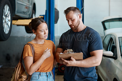 Buy stock photo Woman, mechanic and sign quote in auto repair shop, invoice and service for car maintenance bill. Female person, clipboard and customer for vehicle paperwork, contract and talking in garage workshop