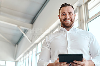 Buy stock photo Shot of a car salesman using his digital tablet