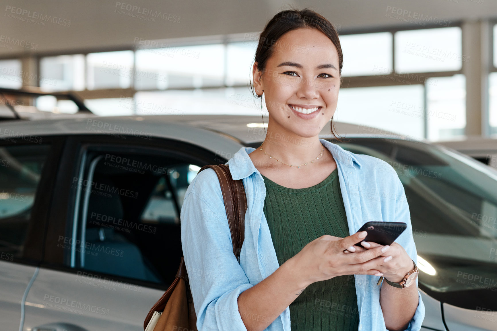 Buy stock photo Asian woman, portrait and phone at car dealership to sale, customer and website for research. Female person, communication and app for vehicle review or online survey, showroom and social media