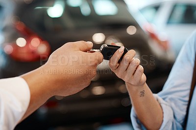 Buy stock photo Shot of a car salesman handing over keys to a customer