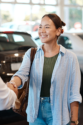 Buy stock photo Shot of a car salesman shaking hands with a customer in greeting