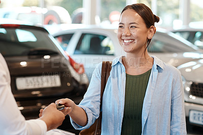Buy stock photo Shot of a car salesman handing over keys to a customer