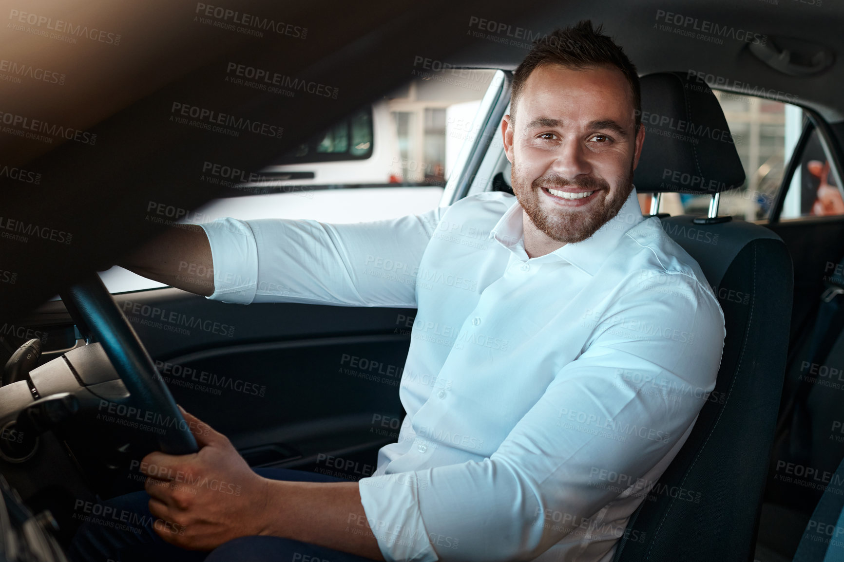 Buy stock photo New car, dealership and portrait of happy man in vehicle for purchase, good service or loan success. Customer, driving and proud driver in showroom for transportation, automobile shopping or warranty