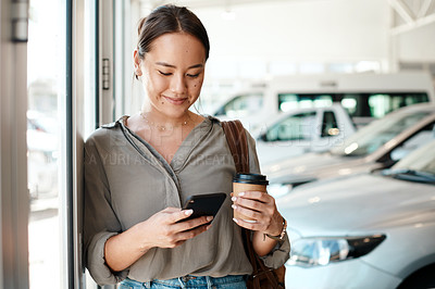 Buy stock photo Phone, coffee and woman at a car dealership typing a text message or scrolling on social media. Communication, technology and female person browsing on a mobile app with a cellphone in a showroom.
