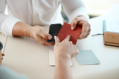 Buy stock photo Shot of a woman choosing between material swatches for her car
