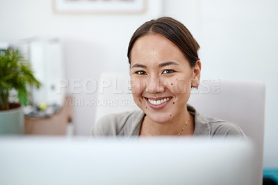 Buy stock photo Shot of a young businesswoman in her office using her computer