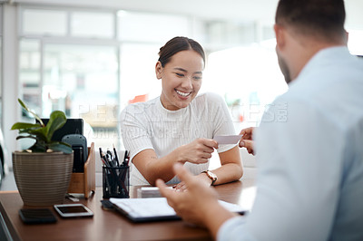 Buy stock photo Shot of a businessman giving his staff member a business card