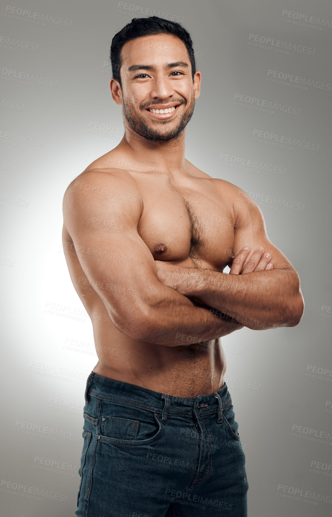 Buy stock photo Man, portrait and confident in studio with abs or muscles, shirtless and grey background with model bodybuilder. Jeans, strong chest and Asian male person on backdrop, happy and smile with six pack