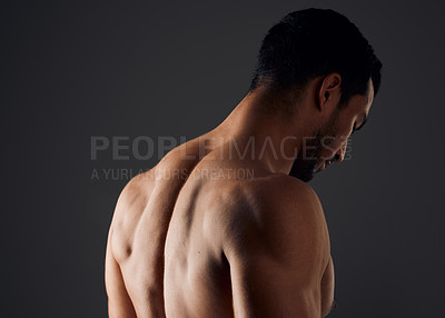 Buy stock photo Shot of an unrecognizable man standing alone in the studio and posing shirtless