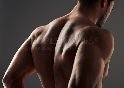 Buy stock photo Cropped shot of an unrecognizable man standing alone in the studio and posing shirtless