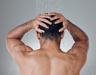 Buy stock photo Shot of an unrecognizable man washing his hair in the shower against a grey background