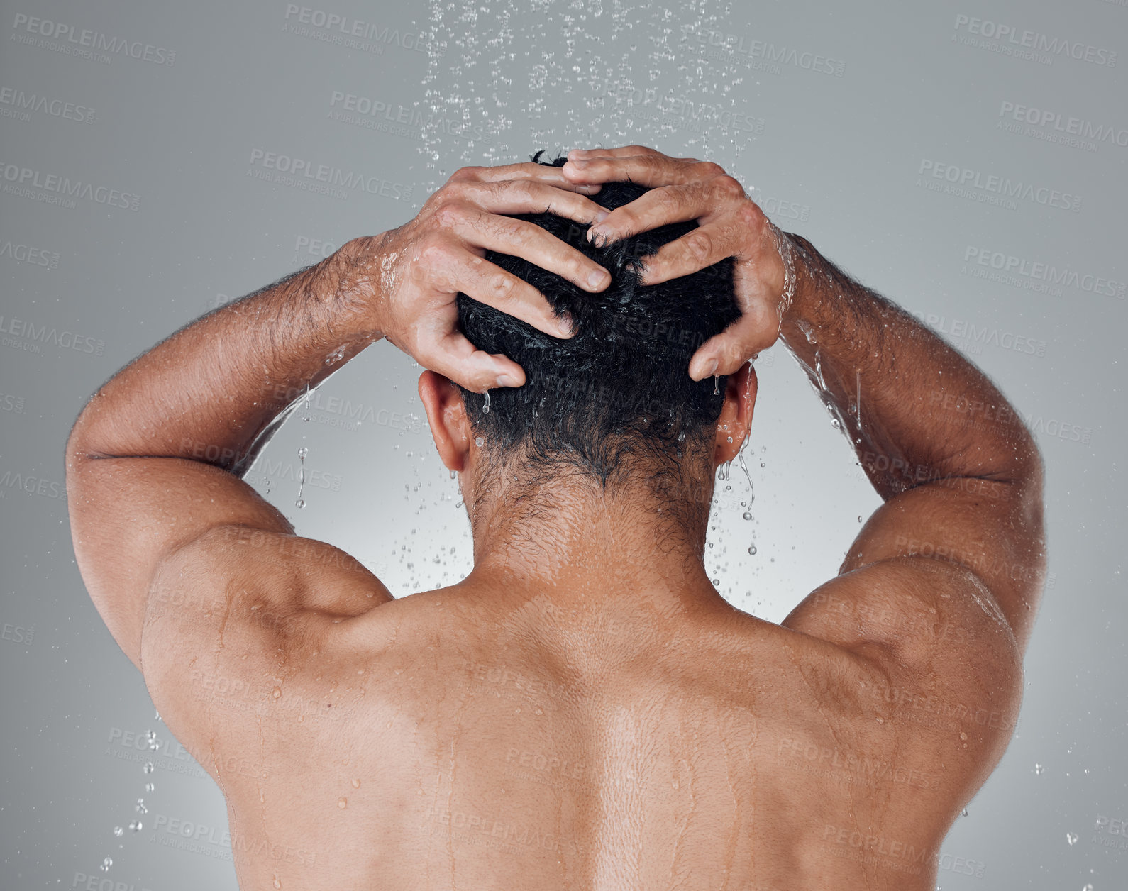 Buy stock photo Shot of an unrecognizable man washing his hair in the shower against a grey background