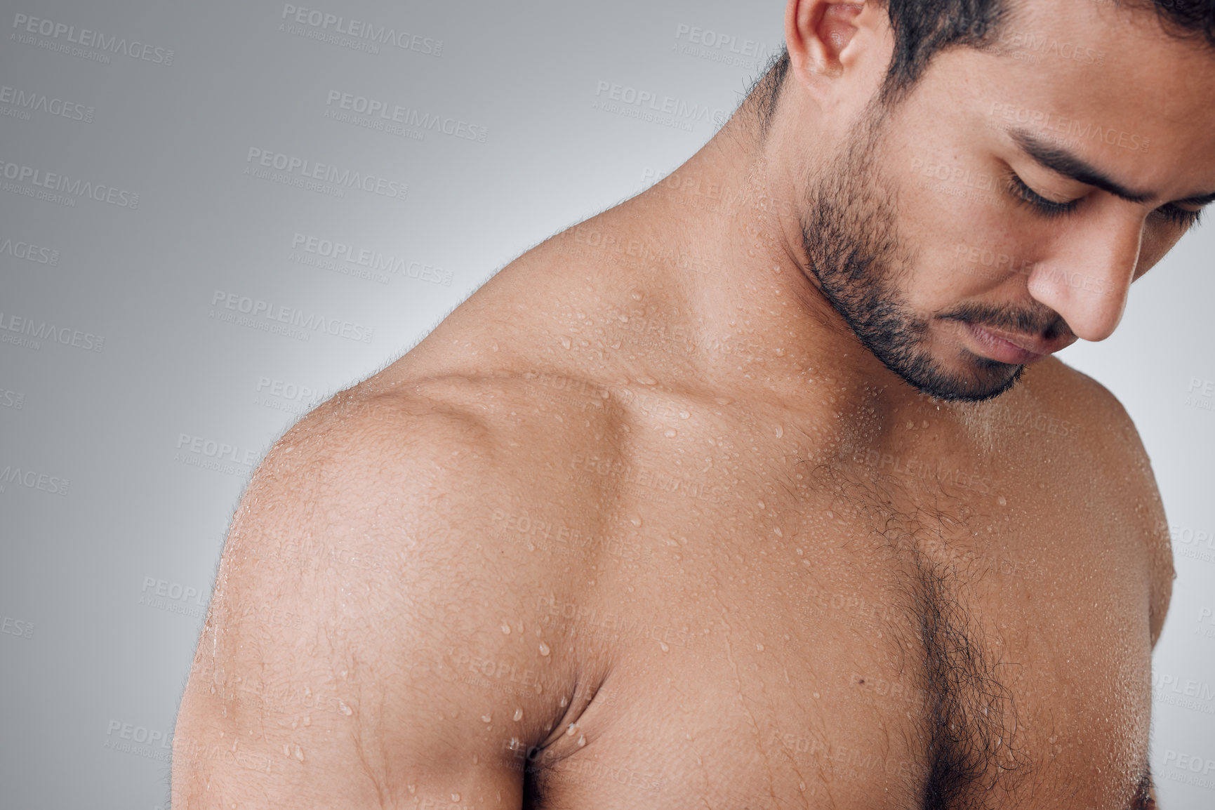 Buy stock photo Water, shower and wet man with muscle and morning self care maintenance, body cleaning or spa salon wellness. Skincare, eyes closed or studio person hygiene on grey background, liquid wash or routine