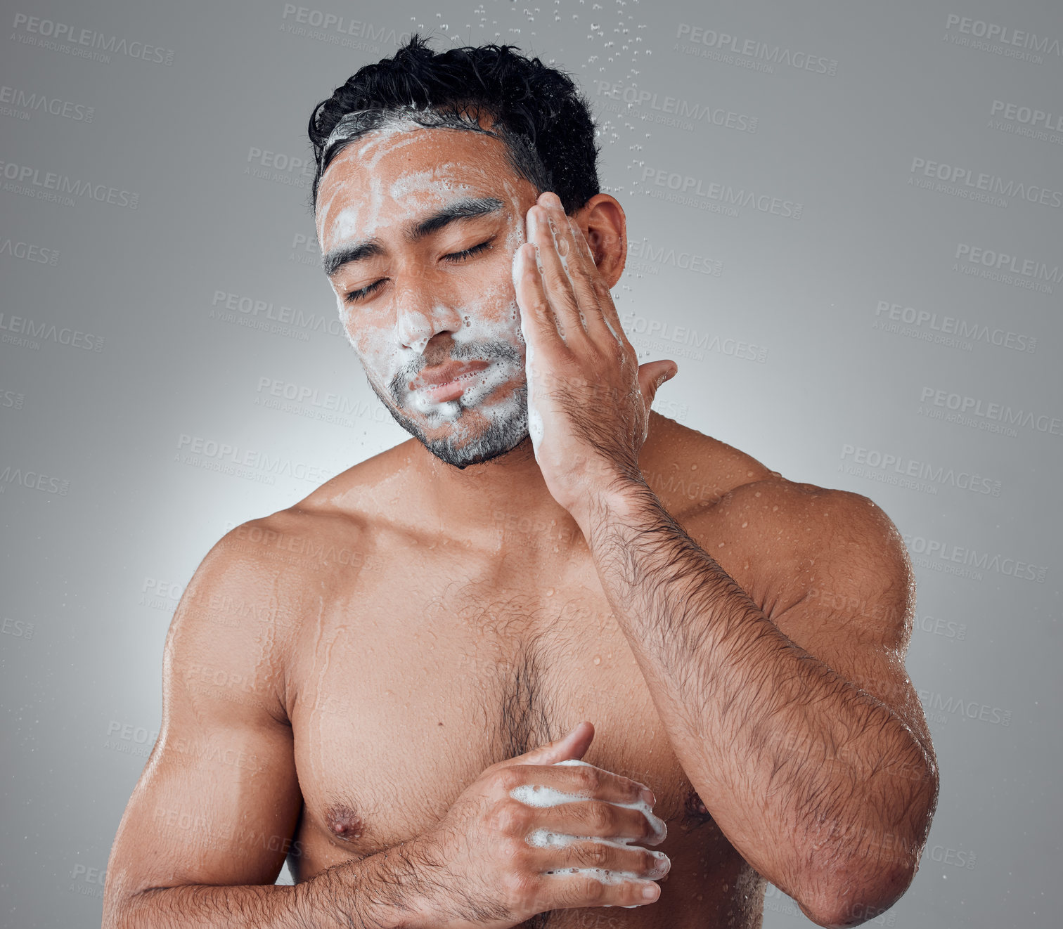 Buy stock photo Man, shower and soap for washing face in studio, water and cleaning or grooming on gray background. Male person, cosmetics and foam for dermatology in morning routine, skincare and facial treatment