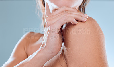 Buy stock photo Studio shot of an unrecognisable woman taking a shower against a blue background