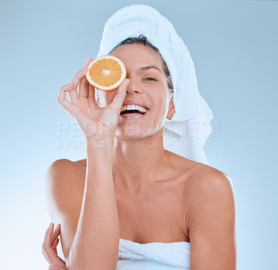 Buy stock photo Woman, portrait and orange for skincare in studio, organic and vitamin c for hydration in skin. Female person, sustainable and fruit for facial treatment, citrus and nutrition on blue background