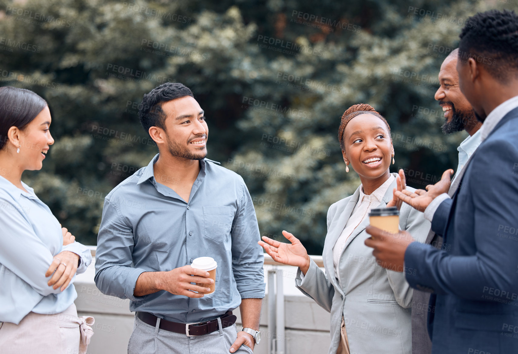 Buy stock photo Shot of a group of businesspeople outside having coffee and conversation