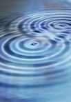 An image of ripples in blue water-like liquid