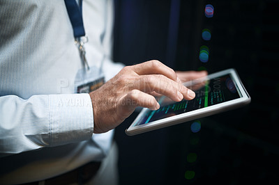 Buy stock photo Closeup shot of an unrecognisable man using a digital tablet while working in a server room