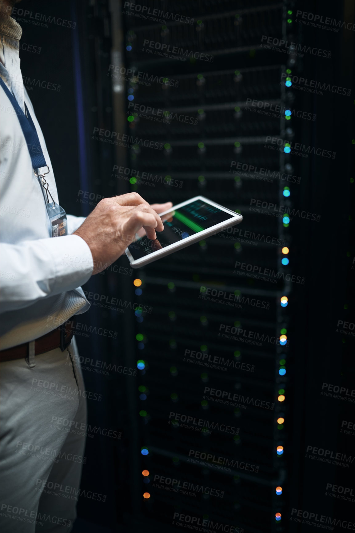 Buy stock photo Closeup shot of an unrecognisable man using a digital tablet while working in a server room